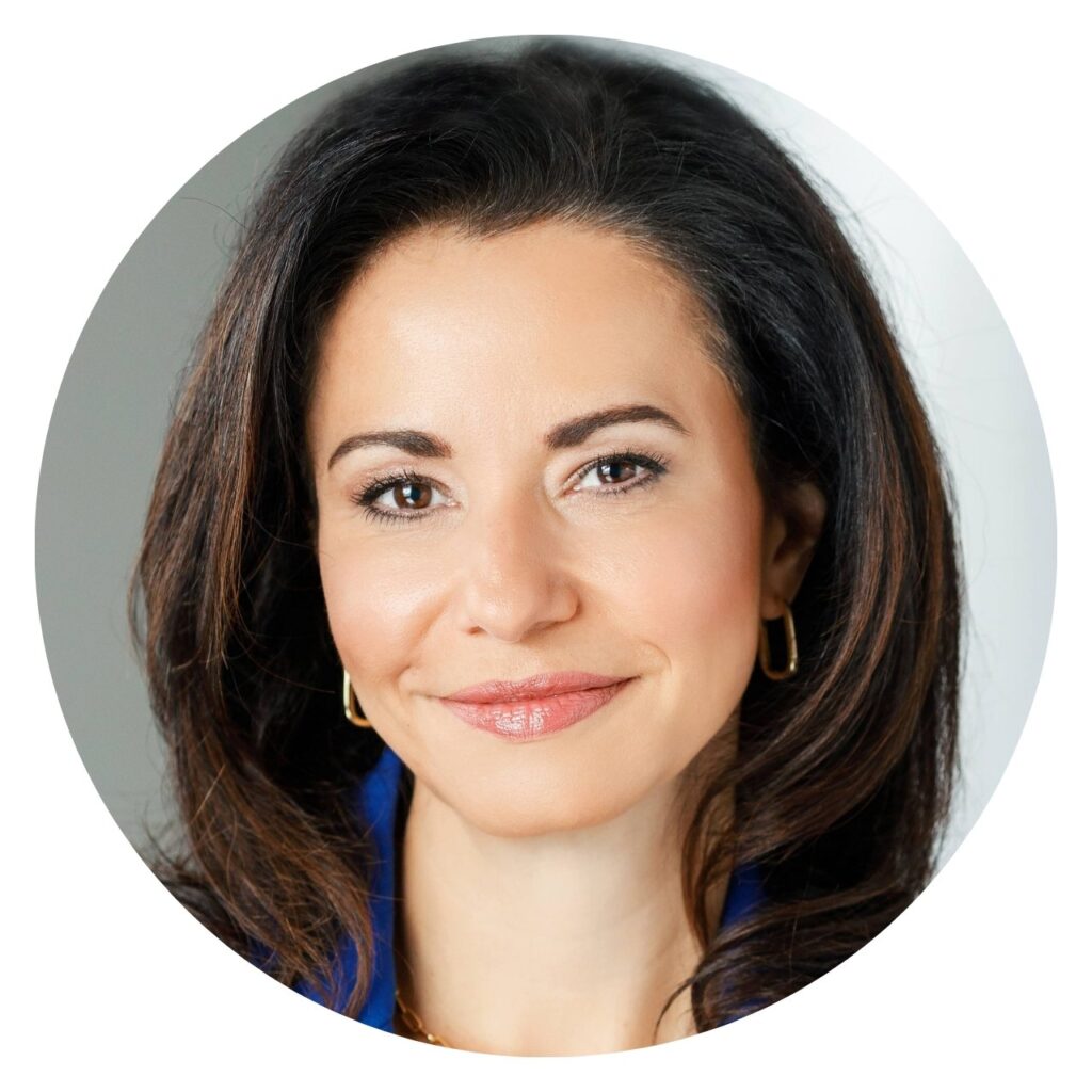 Dr. Gina Sharma, cardiologist, portrait with warm smile and gold earrings