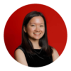 Young woman with dark hair smiles in a black sleeveless top against a red background.