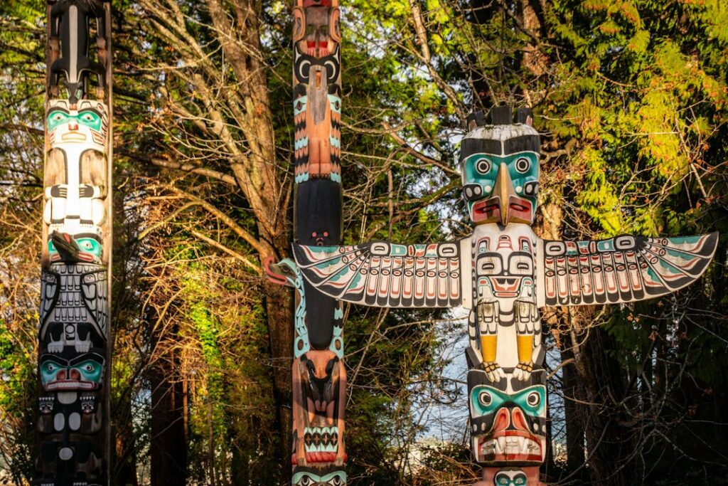 A number of totem poles in a forest