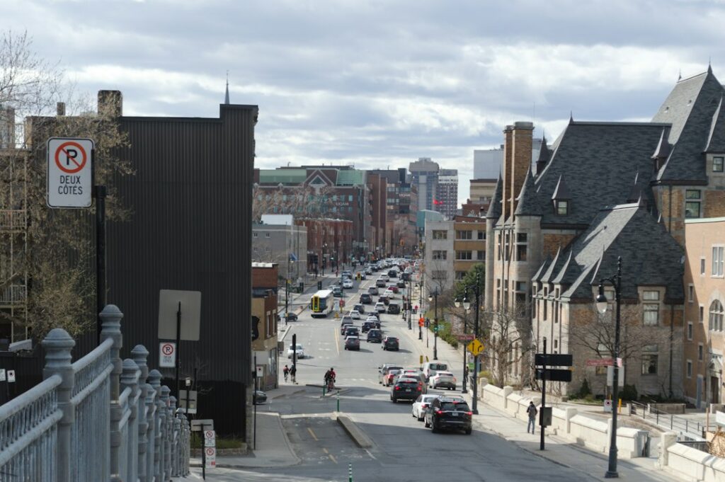 A city street is visible with buildings and traffic