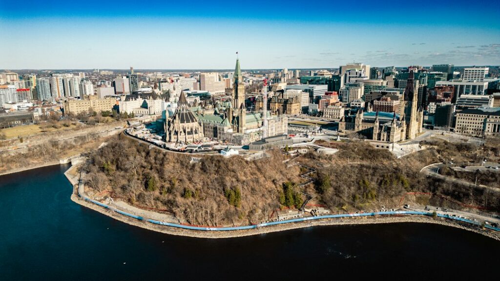 An aerial view of a city with a lake in the foreground