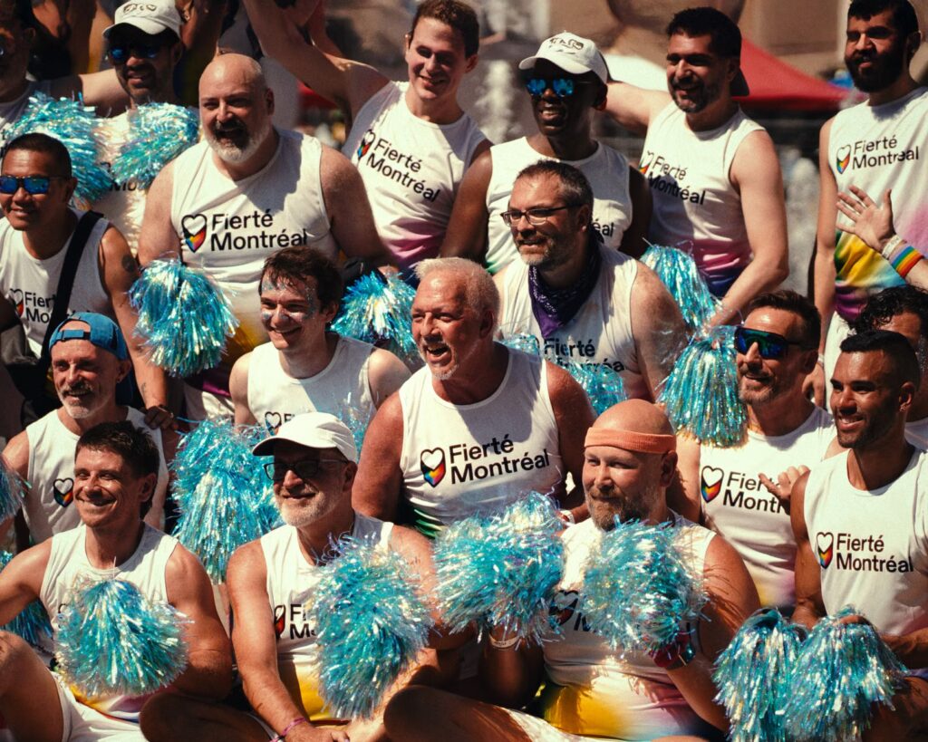 A vibrant group of adults at Toronto's Pride parade celebrating diversity and inclusion.