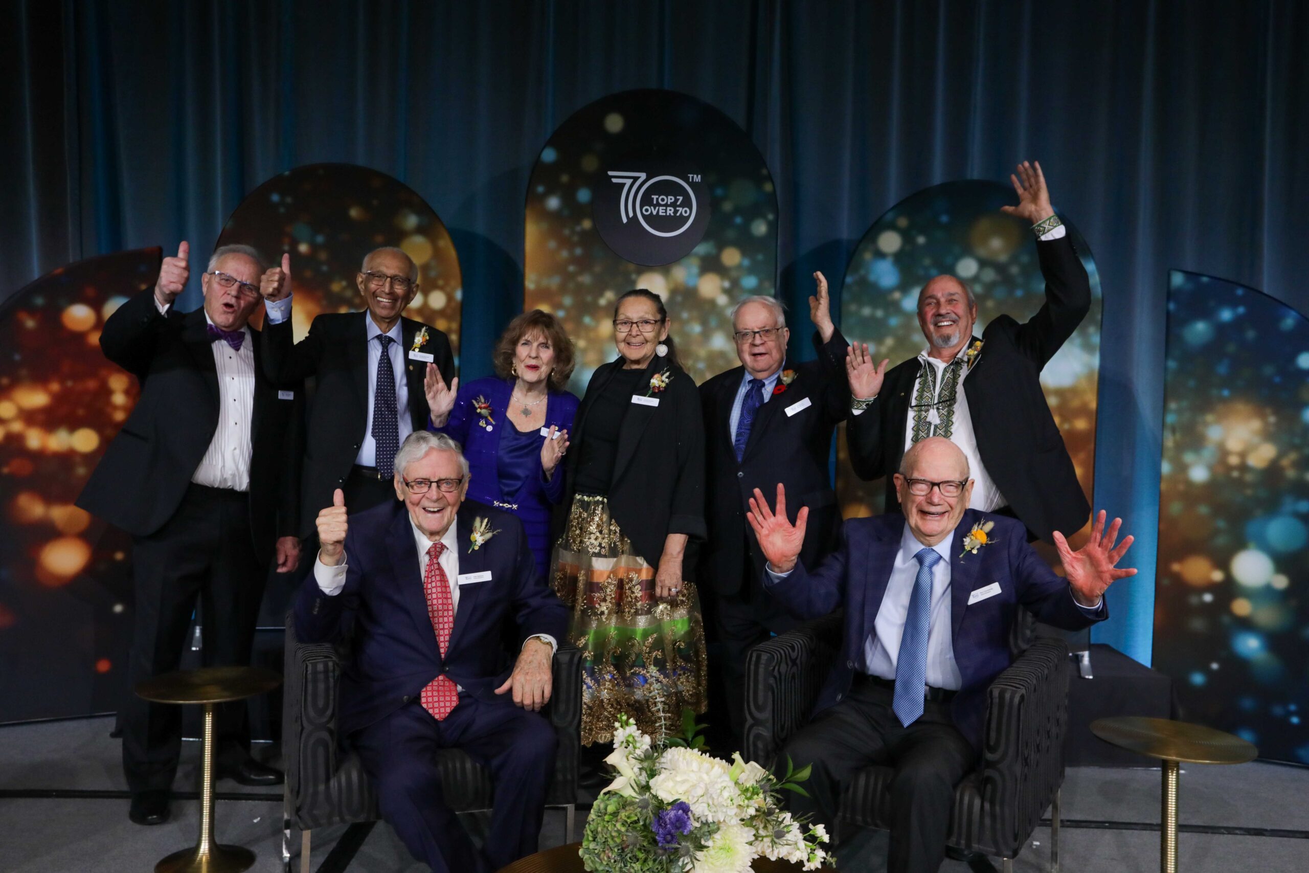 Top 7 Over 70 honourees celebrating on stage